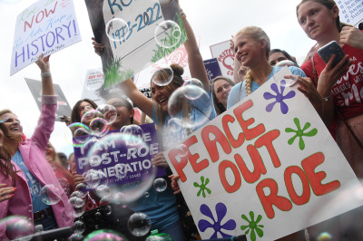 Anti-abortion campaigners celebrate outside the U.S. Supreme Court in Washington, D.C., on June 24, 2022. - The U.S. Supreme Court on Friday ended legal abortion nationwide in one of the most divisive and bitterly fought issues in American political life. The court overturned the landmark 1973 Roe v. Wade decision and said individual states can permit or restrict the procedure themselves.