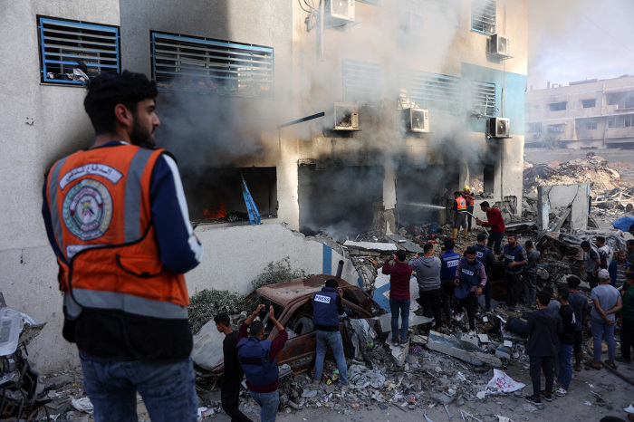 People and rescuers gather as smoke rises from a U.N. school-turned-shelter after it was hit in an Israeli strike, in the Rimal neighbourhood of Gaza City in the northern Gaza Strip on Nov.14, 2024, amid the ongoing war between Israel and the Hamas militant group.