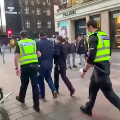Angus Cameron being led away by police in Glasgow city centre.